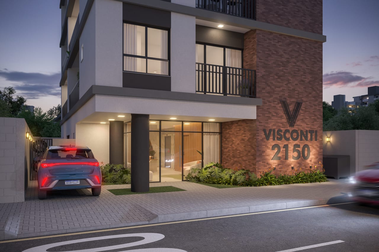Entrada iluminada do Visconti 2150 ao entardecer, na Av. Visconde de Guarapuava, Centro de Curitiba